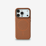 Apple iPhone case in textured brown material with a slim profile, orange camera trim and circular MagSafe ring