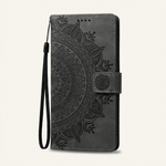 Apple iPhone wallet case in black leather with an embossed mandala pattern, magnetic strap closure and wrist loop