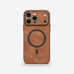Apple iPhone case in warm brown textured leather with black edging, raised camera surround, and MagSafe ring