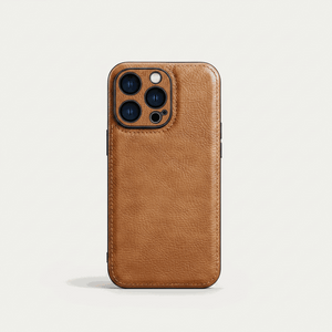 Apple iPhone leather case in warm tan brown, with a textured grain, stitched edges and raised camera surround.