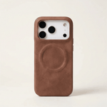 Apple iPhone case in brown textured leather with a slim profile, raised camera edges and a visible MagSafe ring