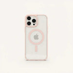 Apple iPhone in a clear hard case with pale pink edges, a pink MagSafe ring, and raised camera protection