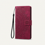 Apple iPhone wallet case in burgundy embossed leather with an ornate floral pattern, magnetic strap and wrist loop