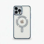 Apple iPhone case with a clear back, dark blue bumper edges, and crystal embellishments around the camera and MagSafe ring