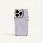 Apple iPhone case with a pale lavender woven fabric texture, smooth solid-color finish and raised metallic camera surround