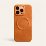 Apple iPhone case in textured orange-brown leather with a raised circular MagSafe ring and protective camera cutouts