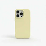 Apple iPhone case in pale yellow liquid silicone with a smooth matte finish and raised camera-lens surround