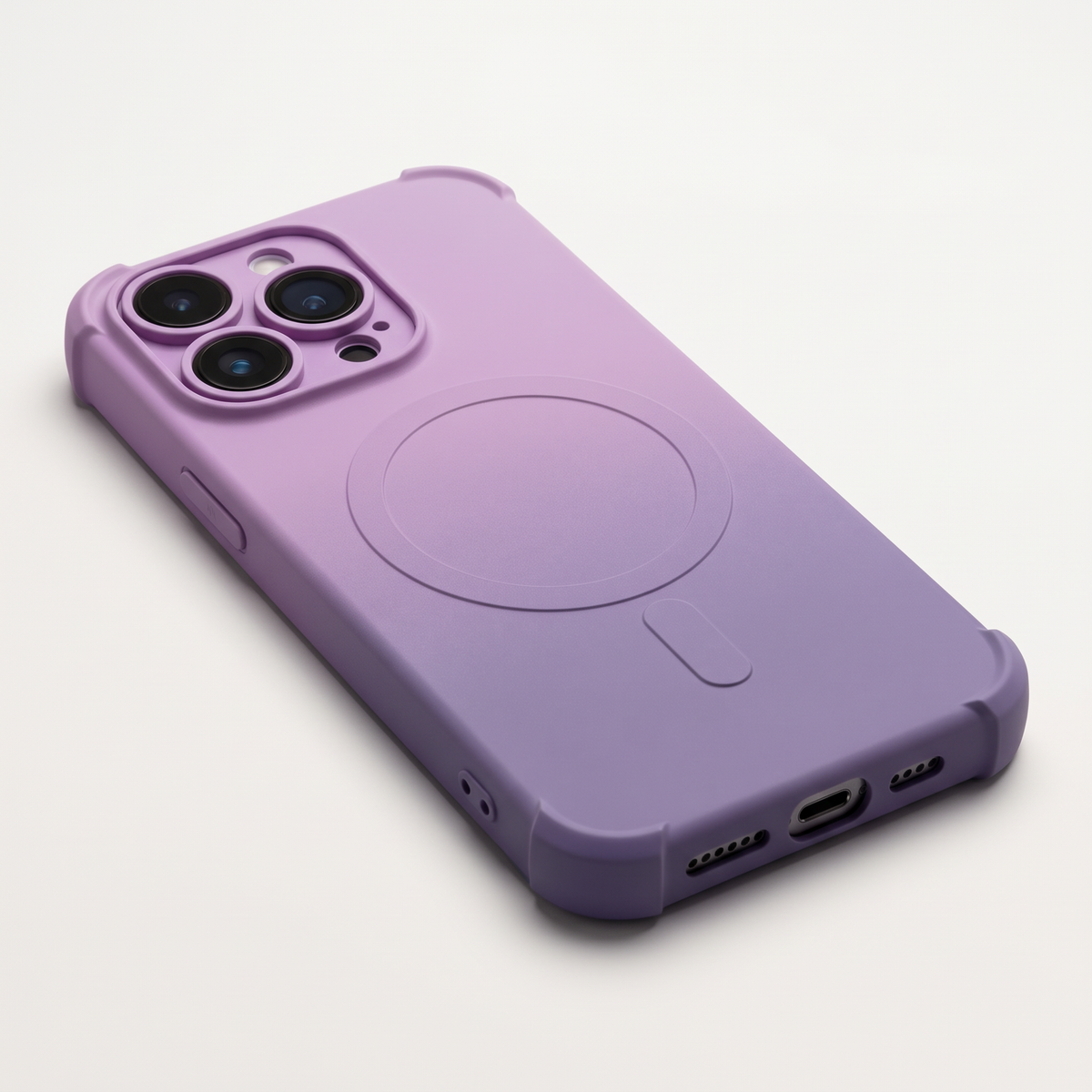 Apple iPhone silicone case in a pink-to-purple gradient with a matte finish, raised camera guard and MagSafe ring