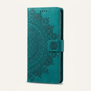 Apple iPhone wallet case in teal embossed leather with an ornate mandala pattern and magnetic side strap