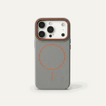 Apple iPhone case in textured gray material with orange MagSafe ring and accent, plus a raised camera rim
