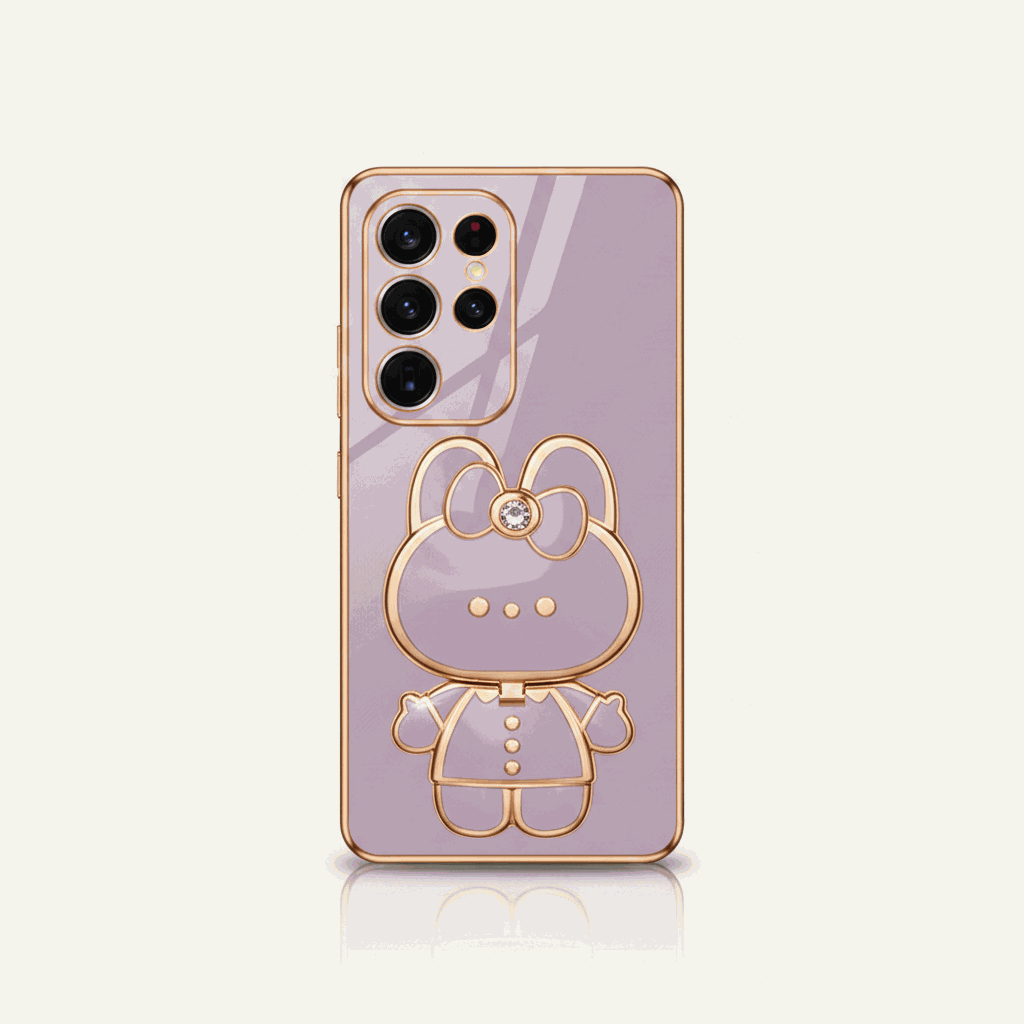 Samsung Galaxy phone case in lavender with a reflective finish and raised gold-tone bear character design with bow