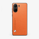 Xiaomi Sleek Leather Look Case in textured orange leather-look material, with black dual-camera cutout and silver accent